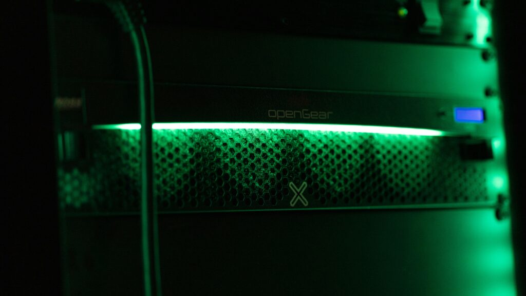 A server room with blinking lights, representing data storage and hosting infrastructure.