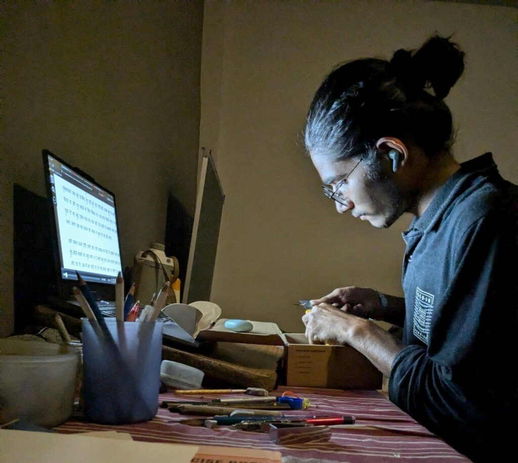 A person working on a laptop, designing a website.